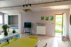 ein Wohnzimmer mit einem Tisch und einem Bett in der Unterkunft Les Jardins de La Palaire - Gîte T2 avec jardin in Cugand