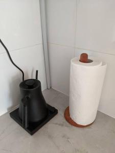 a roll of toilet paper sitting next to a trash can at Apt Pejaten Park 1 BR Sage Smart TV, Netflix, Prime, Youtube in Jakarta
