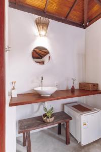 a bathroom with a sink and a mirror at Pousada Habitat Caraiva in Caraíva