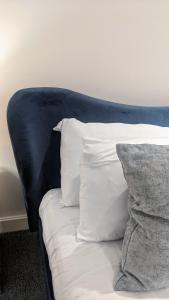 a blue couch with white pillows on it at #Huge Master Suite #Self check in #Very central!!! in York