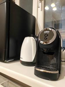 a coffee maker sitting on a counter next to a computer monitor at Freska Apartments in Lviv