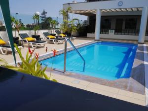 a pool at a hotel with chairs and tables at Hotel Boulevard in Lima