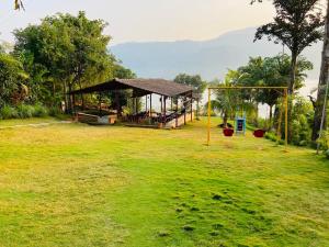 a park with a gazebo and a playground at Lakeview Resort Lavasa in Lavasa