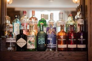 a group of bottles of alcohol sitting on a bar at The Smiddy Haugh in Auchterarder