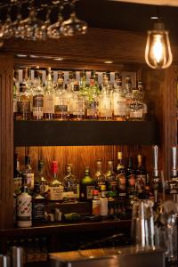 a shelf filled with lots of bottles of alcohol at The Smiddy Haugh in Auchterarder