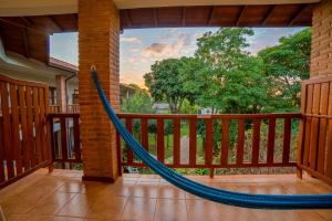 a hammock on a porch with a view at Pousada Girassol in Bonito