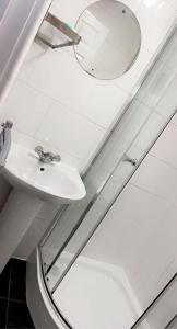 a bathroom with a sink and a mirror at CityNights Studios with Free Parking in Liverpool