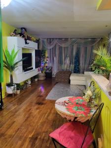 a living room with a couch and a table at Joy's Country Home in Brooklyn