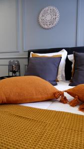 a bed with an orange blanket and pillows on it at O Cantinho do Colégio in Lamego