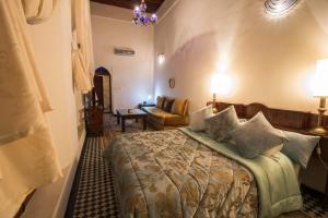 Postel nebo postele na pokoji v ubytování Riad Noujoum Medina