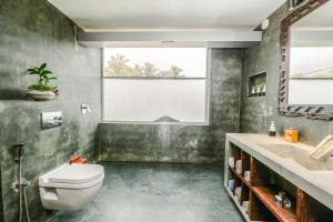 a bathroom with a toilet a sink and a bath tub at Waterland in Negombo