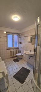 a bathroom with a toilet and a sink and a shower at Hotel Lamm in Stuttgart