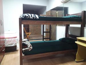 a room with two bunk beds in a room at Hostel Salazar in Campo Grande