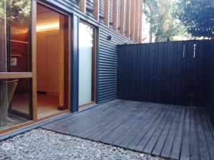 una casa con una valla negra y una terraza de madera en EDIFICIO VIVERo 3, en San Martín de los Andes