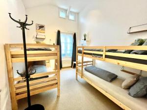 a room with three bunk beds in a room at VIVA Hostel in Chur