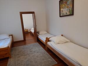 two beds in a room with a mirror at Apartament in Rydzewo