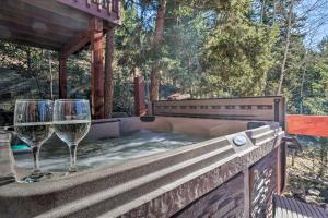 dos copas de vino sentadas en la parte trasera de un porche en Expansive Mountain Retreat with Views of Pikes Peak!, en Woodland Park
