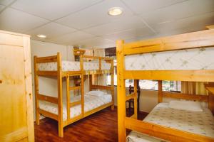a bunk bed with two bunk beds in a room at Nativus Hostel Machu Picchu in Machu Picchu