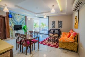 a living room with a table and a dining room at La Famille Guest House-Families Onlyللعوائل فقط in Durat Alarous