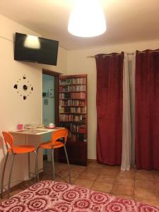 a room with a table and chairs and a book shelf at Scibetta's B&B in Taranto