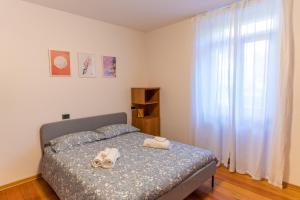 a bedroom with a bed with shoes on it at Casa Lena in Ledro