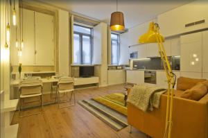 a kitchen and living room with a couch and a table at 01 Design Flat in Porto Downtown in Porto