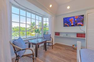 a dining room with a table and chairs and a window at Sunshine Studio at Viking Hill - Love Beach in Nassau