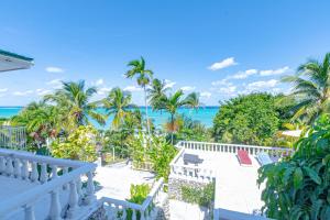 a view of the ocean from the balcony of a house at Sunshine Studio at Viking Hill - Love Beach in Nassau
