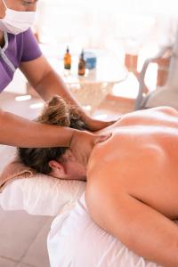 a shirtless man getting a massage from a therapist at Hotelito Los Sueños in Sayulita