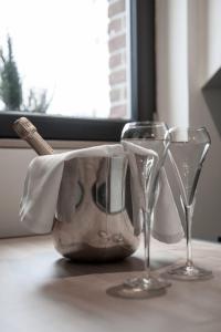 two wine glasses sitting on a table with a napkin at Le Vivier in Amiens