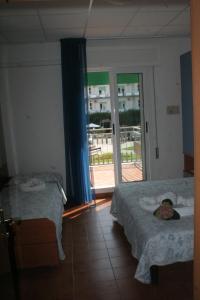 Postel nebo postele na pokoji v ubytování Hotel Trifoglio