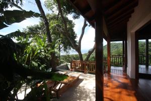 a porch of a house with a view of the ocean at Canta La Rana in Bejuco