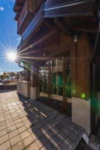 a building with the sun shining through the doors at V&Dj in Zlatibor