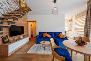 a living room with a blue couch and a table at V&Dj in Zlatibor