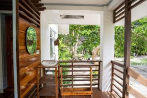 a bathroom with a sink and a window at YAMA APARTMENTS - Private Beachfront in General Luna