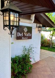 a sign for a del valle resort on a building at Hostal del Valle in Santa Cruz