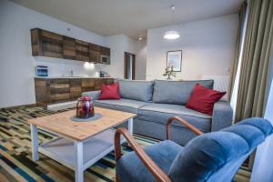 a living room with a couch and a table at Apartamenty Na Wyspie - Baltic Molo - Parking in Świnoujście