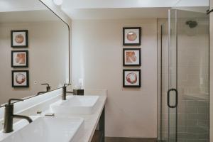 a bathroom with two sinks and a shower at Huntley Lodge at Big Sky Resort in Big Sky