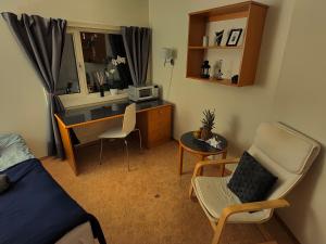 a bedroom with a desk and a chair and a table at Vistula Oslo in Oslo
