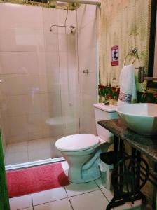 a bathroom with a toilet and a shower and a sink at Hostel Aroeira do campo in Florianópolis +36 photos