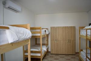 a dorm room with bunk beds and cabinets at Me & You Hostel in Tirana