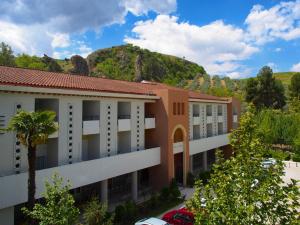 a view of a building with a mountain in the background at Balneario de Alhama de Granada in Alhama de Granada