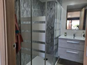 a bathroom with a glass shower and a sink at Cielo y mar in Marín