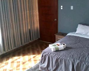 a bedroom with a bed with a roll on it at Tumalki Rooms in Trujillo