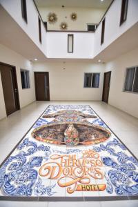 a room with a tile floor with a painting on it at HOTEL MI HERMOSO DOLORES in Dolores Hidalgo
