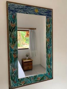 espejo que refleja una habitación con ventana en Casinha no centro, en Trancoso