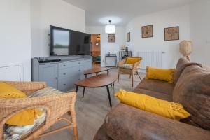 a living room with a couch and a table at Cocooning tower - Fairytale Factory in Bussy-Saint-Georges
