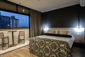 Postel nebo postele na pokoji v ubytování URBAN by UNU Osasco Hotel