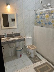 a bathroom with a toilet and a sink and a shower at Chalé Bella Vista in Guaramiranga +60 photos