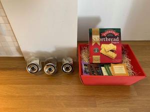 a red box filled with cheese and a box of ammunition at Bright House with Garden & Patio in Market Town in Inverurie